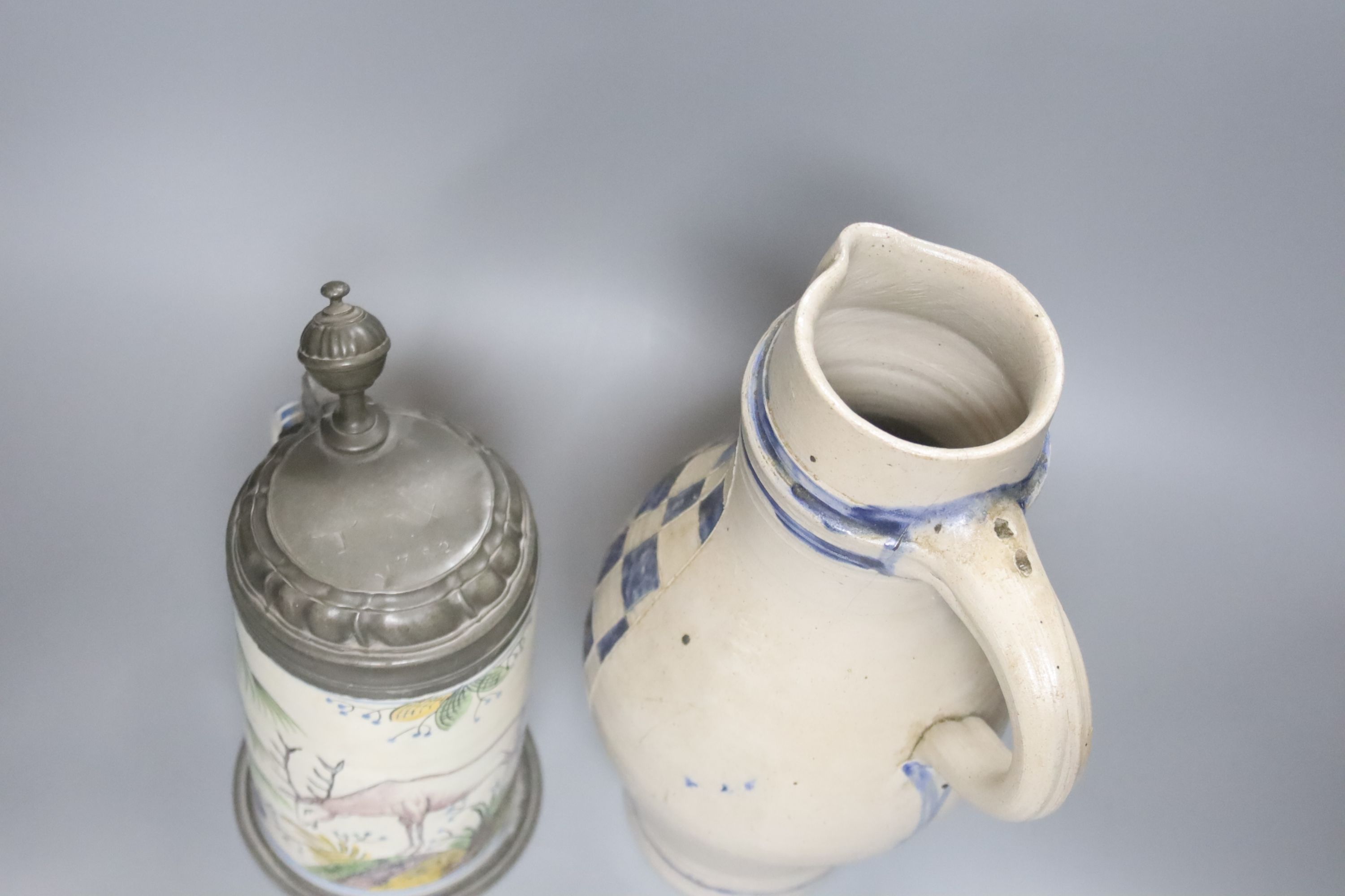 An 18th/19th century German faience pewter-mounted stein decorated with a stag and a German stoneware pitcher, height 25cm & 30cm